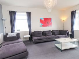 A living room with a sofa and coffee table at Sea Views No 8 Plas Darien, Trearddur Bay