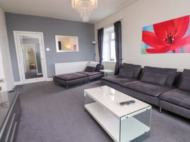 A living room with a sofa and coffee table at Sea Views No 8 Plas Darien in Trearddur Bay