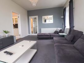 A living room with a sofa and coffee table at Sea Views No 8 Plas Darien Trearddur Bay