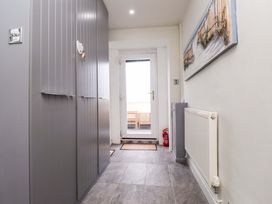 A hallway with storage cabinets and a door leading outside at Sea Views No 8 Plas Darien Trearddur Bay