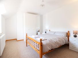 A bedroom with a bed and wardrobe at Gwernffridd