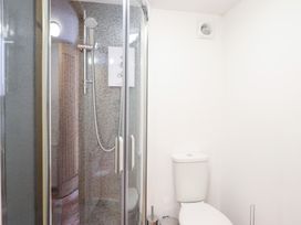 A bathroom with a shower and a toilet at Gwernffridd