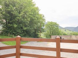 An outdoor scene with trees and a fence at Gwernffridd