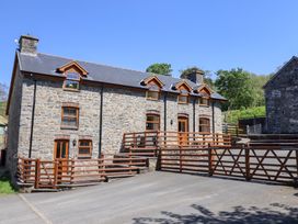 A stone building with windows and fenced entrance at Gwernffridd near Pennant in Llanbrynmair
