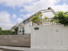 A house with a sign and fence at 1 Island View in Thurlestone