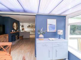 A kitchen featuring a cabinet and decorative elements at 1 Island View Thurlestone