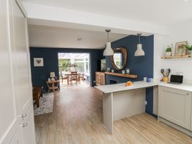 A kitchen with a dining area and television at 1 Island View in Thurlestone