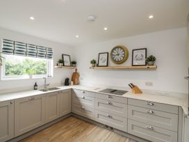 A kitchen with cabinets and a countertop at 1 Island View in Thurlestone