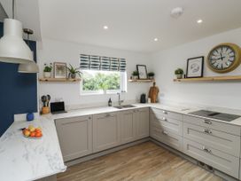 A kitchen with cabinets and countertop at 1 Island View in Thurlestone