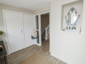 A hallway with a mirror and key holder at 1 Island View in Thurlestone