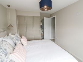 A bedroom with a bed and wardrobe at 1 Island View in Thurlestone