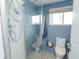 A bathroom with a shower and toilet at 1 Island View in Thurlestone