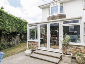 A conservatory with windows and steps at 1 Island View Thurlestone