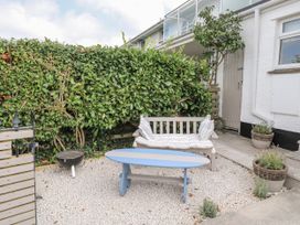 A garden with a bench and coffee table at 1 Island View Thurlestone