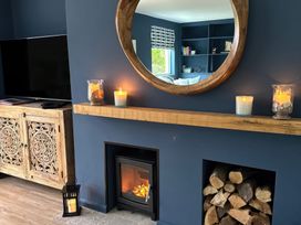 A living room with a fireplace and television at Thurlestone, 1 Island View in Thurlestone