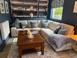 A living room with a sofa and coffee table at Thurlestone, 1 Island View in Thurlestone