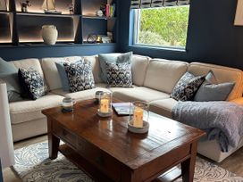 A living room with a sofa and coffee table at Thurlestone, 1 Island View, Thurlestone