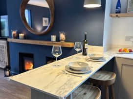 A kitchen with a marble counter and wine bottle at Thurlestone, 1 Island View, Thurlestone