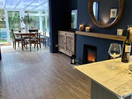 A conservatory with a dining table and chairs at Thurlestone, 1 Island View in Thurlestone