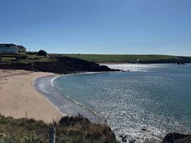 A beach and water view with cliffs and buildings at Thurlestone, Thurlestone