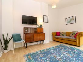 A living room with a sofa and television at The Cow Shed in 