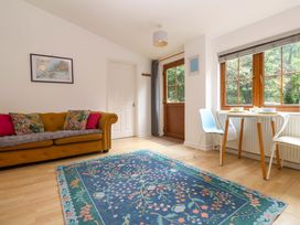 A living room with a sofa and a dining table at The Cow Shed in 