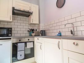 A kitchen with appliances and a sink at The Cow Shed
