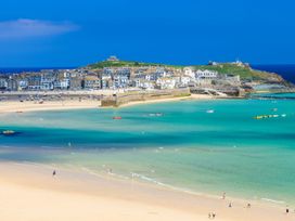 A coastal scene with buildings and beach at The Cow Shed in 