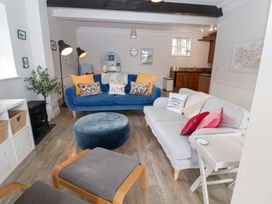 A living room with a blue sofa and decorative items at Old Felixstowe, Bath Road, Felixstowe, Suffolk