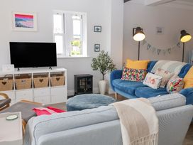 A living room with a television, sofa, and coffee table at Old Felixstowe, Bath Road, Felixstowe, Suffolk