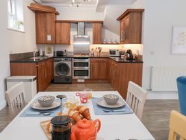 A kitchen with appliances including a stove and refrigerator at Old Felixstowe, Bath Road, Felixstowe, Suffolk