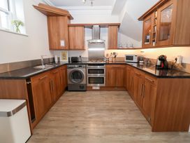A kitchen with wooden cabinets and appliances at Old Felixstowe, Bath Road Felixstowe, Suffolk