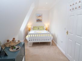 A bedroom with a bed and bedside table at Old Felixstowe, Bath Road, Felixstowe, Suffolk