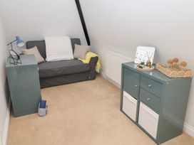 A snug area with a sofa and shelving unit at Old Felixstowe, Bath Road, Felixstowe, Suffolk