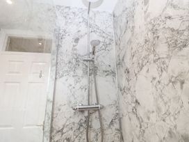 A shower with a marble wall and glass enclosure at Old Felixstowe, Bath Road, Felixstowe, Suffolk