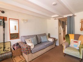 A living room with a sofa and an armchair at 2 The Square, Hope Cove