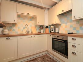 A kitchen with sink and oven at 2 The Square, Hope Cove
