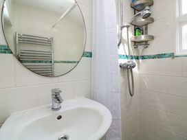 A bathroom with a sink and a shower at 2 The Square in Hope Cove