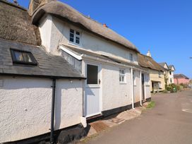 A house with a thatched roof and a front door at 2 The Square Hope Cove