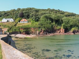 A view of houses on a cliff by the water at 2 The Square Hope Cove