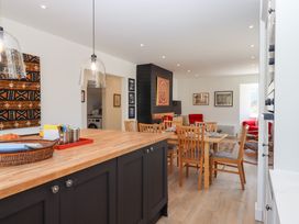 A kitchen with a dining area and artwork at Clova Brixham