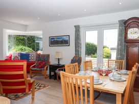 A dining room with a table and chairs at Clova in Brixham