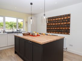 A kitchen with an island and windows at Clova in Brixham