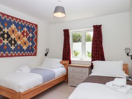 A bedroom with two single beds and a dresser at Clova in Brixham
