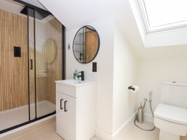 A bathroom with a shower, sink, and toilet at Clova, Brixham