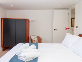 A bedroom with a bed and wardrobe at Clova in Brixham