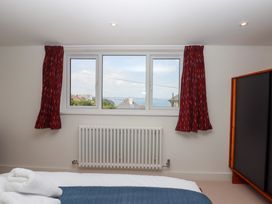 A bedroom with a window and radiator at Clova in Brixham