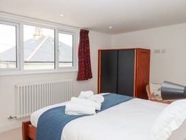 A bedroom with a bed and a wardrobe at Clova Brixham