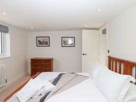 A bedroom with a bed and dresser at Clova in Brixham