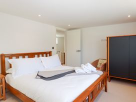 A bedroom with a bed and wardrobe at Clova in Brixham